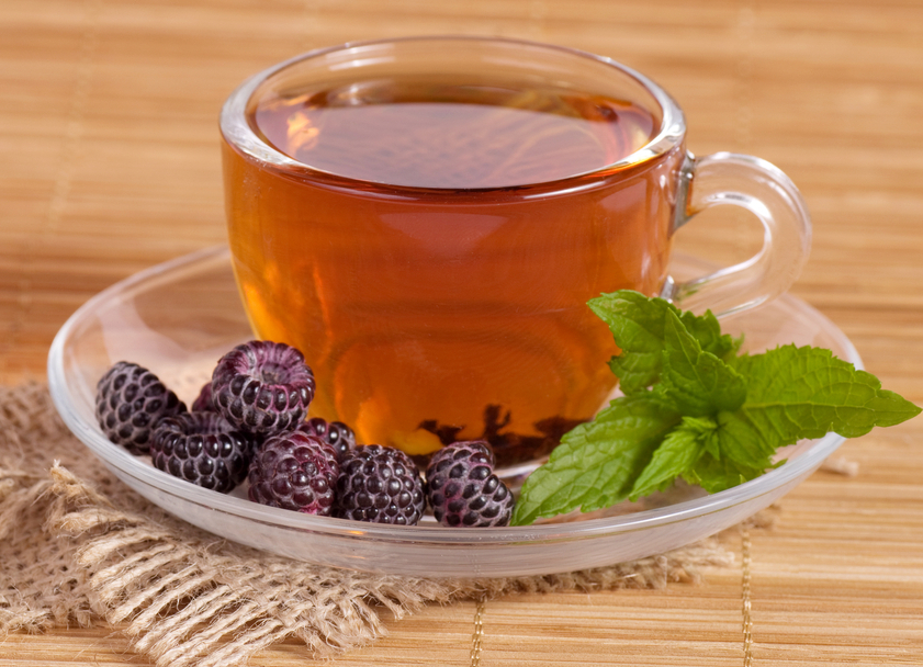 Fruit tea(tea package) in cup with blackberry