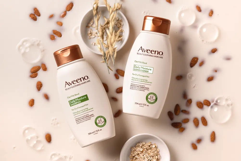AveenoÂ® Daily Moisture haircare set displayed with its nourishing ingredients fit for all hair types